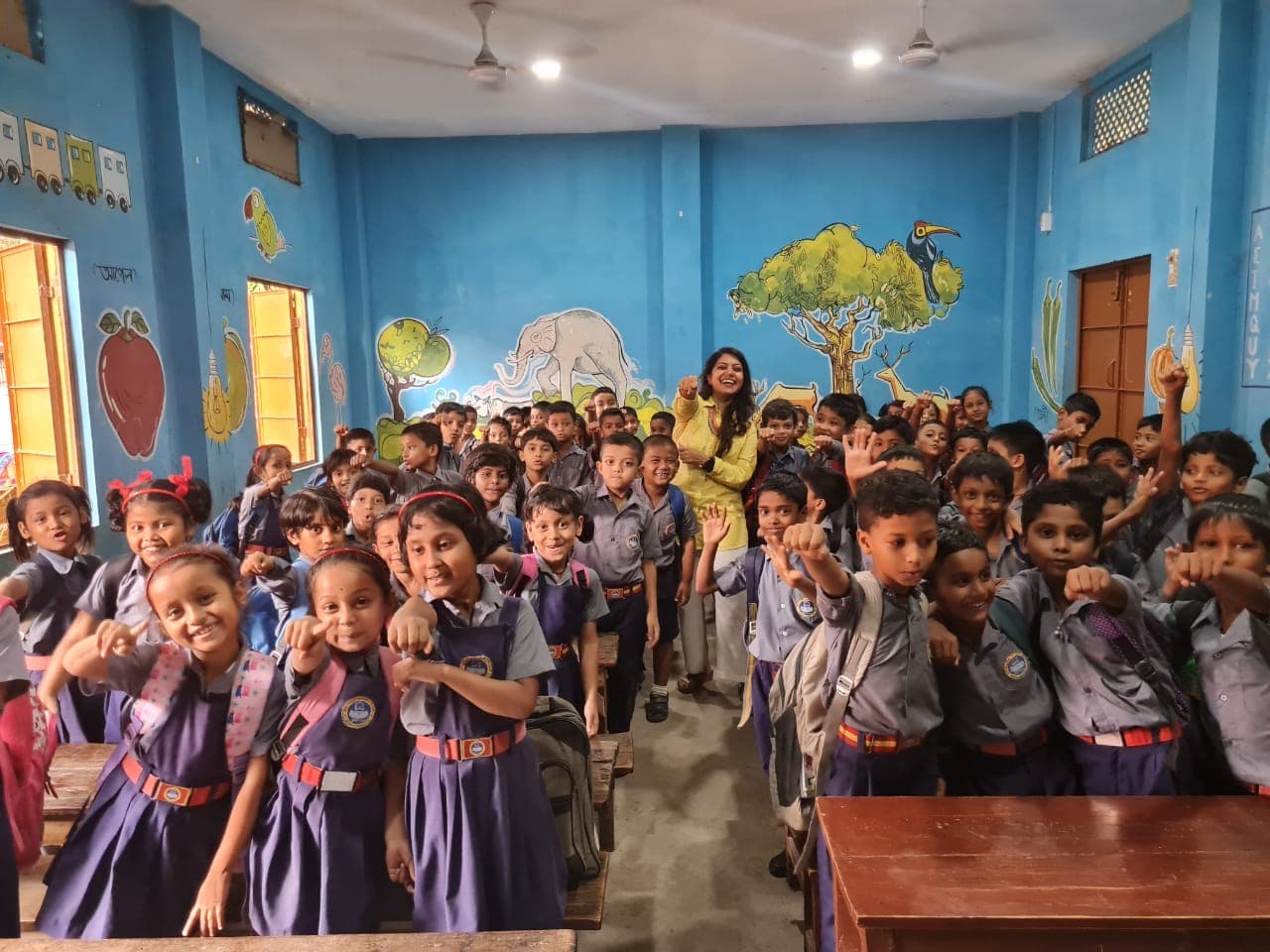 Smiling school children with their teacher