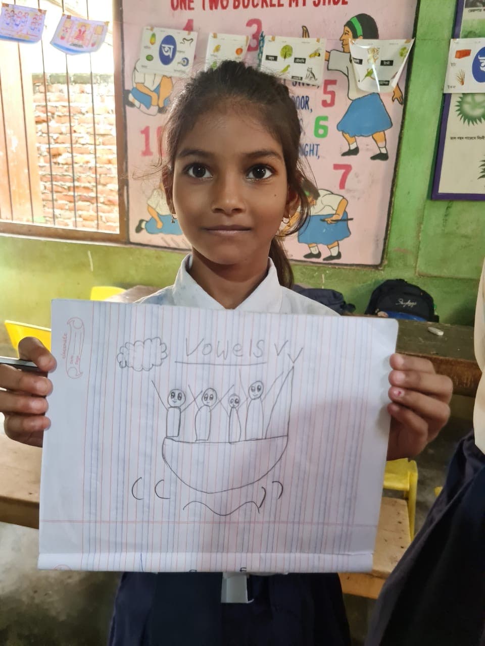 A student sharing her vowel activity drawing